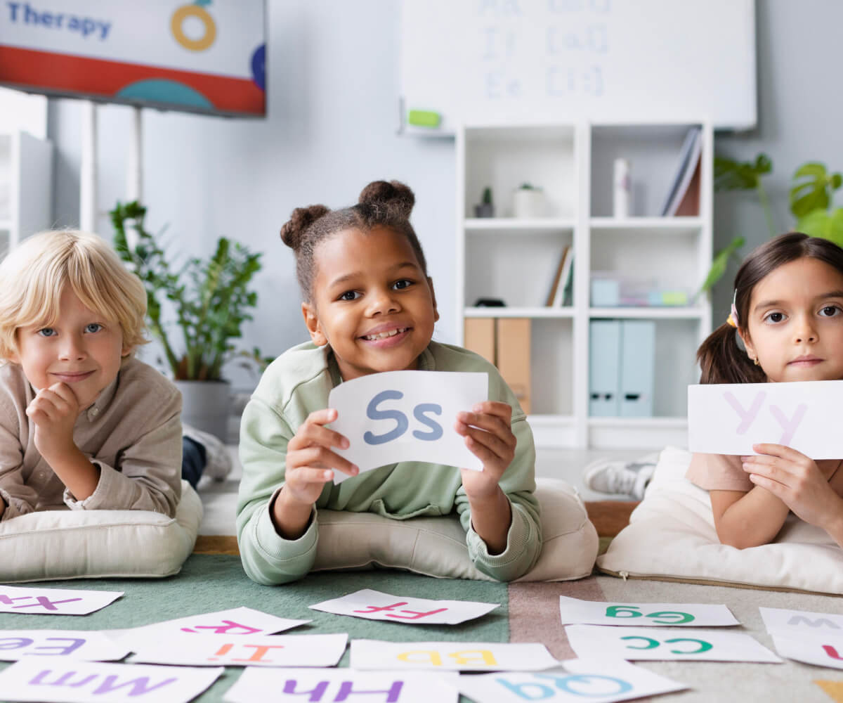 Group of children showing completed art project in preschool classroom